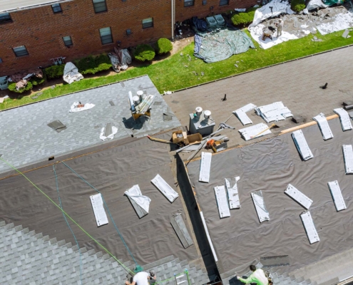 Overhead View Of Apartment Roof Being Replaced
