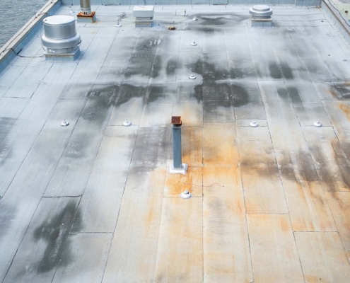 Overhead View Of A Commerical Roof With Water Damage